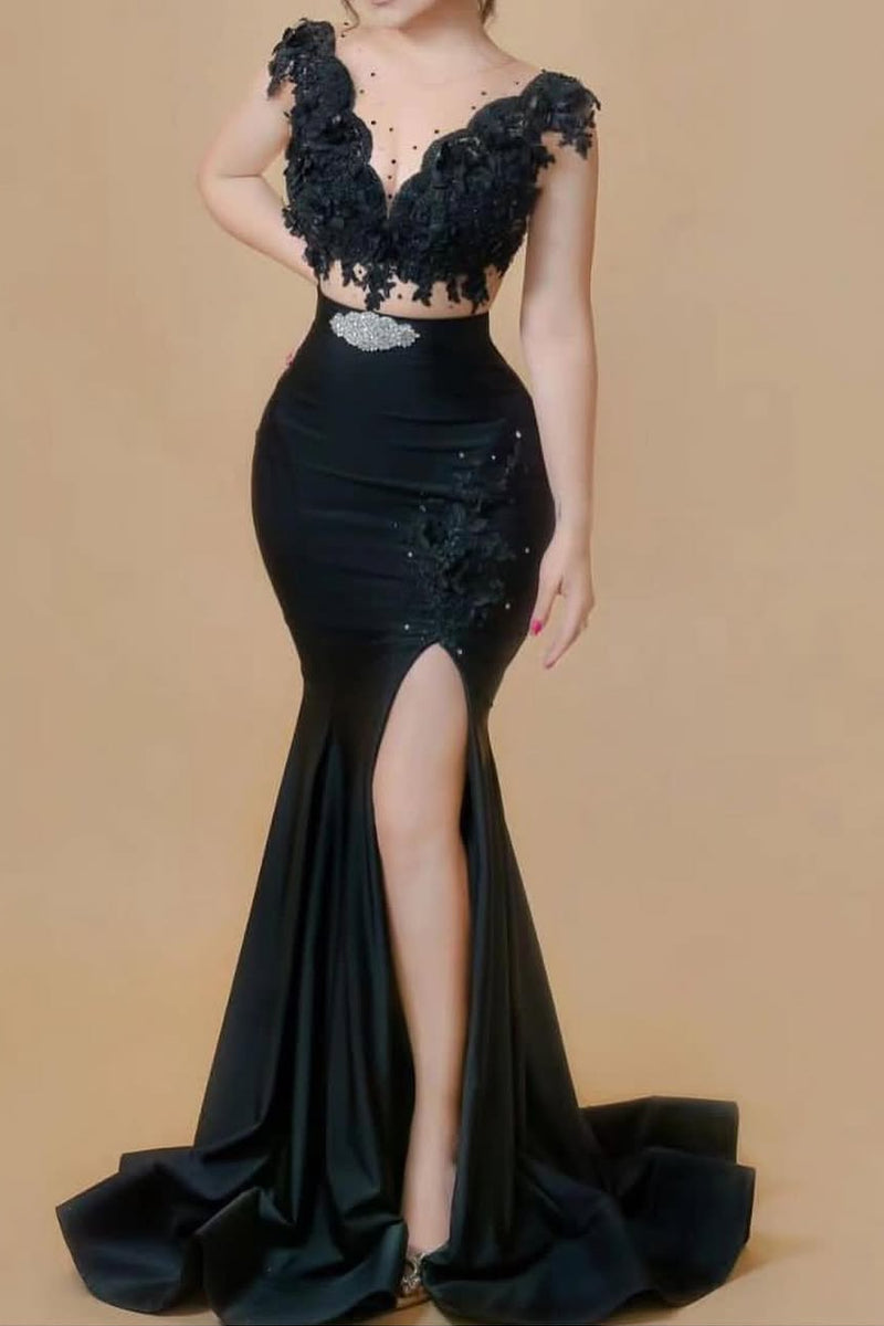Black evening gown with floral lace details on a beige background
