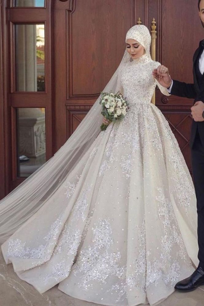 Looking for a dress in Satin, A-line style, and Amazing Appliques,Sequined work? We meet all your need with this Classic A-line Ball Gown Sequins Long Sleeves Highneck Wedding Gown.