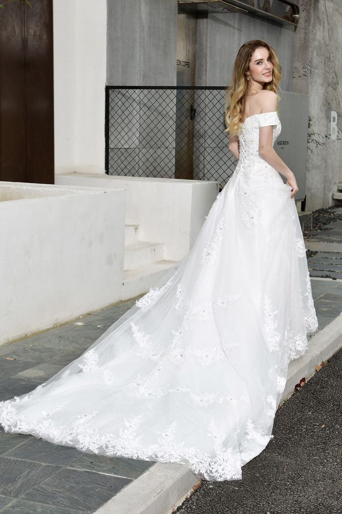 Looking for a perfect dress for your big day. Ballbella has Classic White Lace Off-the-Shoulder Wedding Dress avilable in White, Ivroy and champange. Try this simple bridal gowns for your summer wedding.