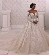 Searching for a dress in lace, A-line style, and delicate Lace,Pearls work? We meet all your need with this Classic Designer Off-theshoulder Lace Princess White wedding dress at factory price.
