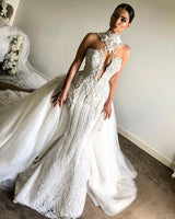 Wanna get a perfect dress for big day? We meet all your need with this Classic Luxurious High Neck Mermaid Sleeveless Wedding Dress latest Lace Appliques Overskirt Bridal Gown.