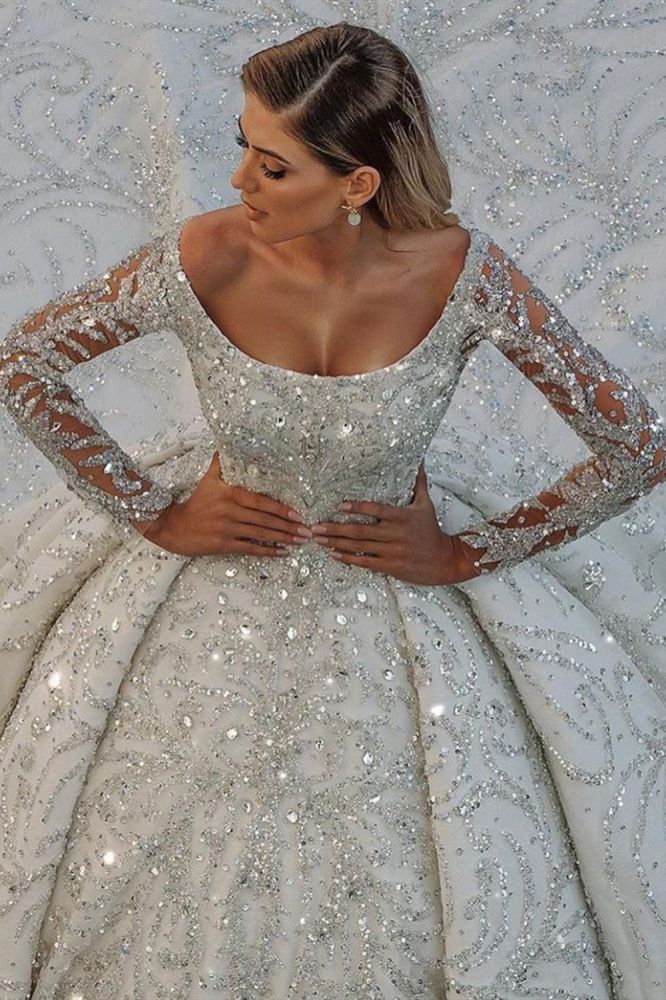 Looking for a dress in Satin, A-line style, and AmazingBeading,Sequined work? We meet all your need with this Classic Luxurious Princess Ball Gown Long Sleevess Sparkly sequins Bridal Gowns with Sweep Train.