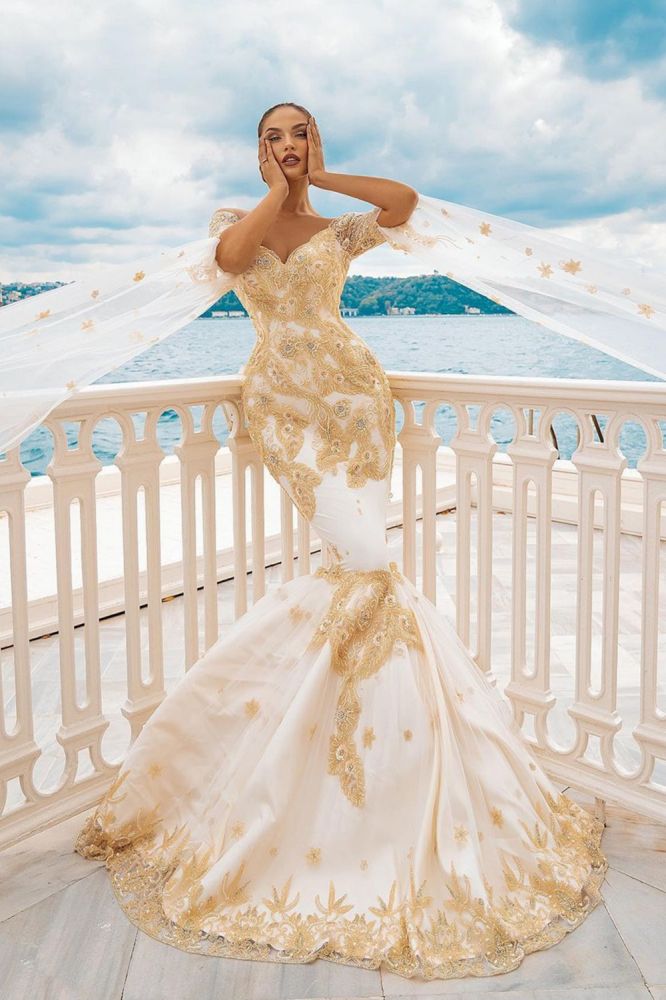 Ballbella offers Mermaid Bridal Gowns Gold Appliques Half Sleeve Cape at a good price, 1000+ options, fast delivery worldwide.