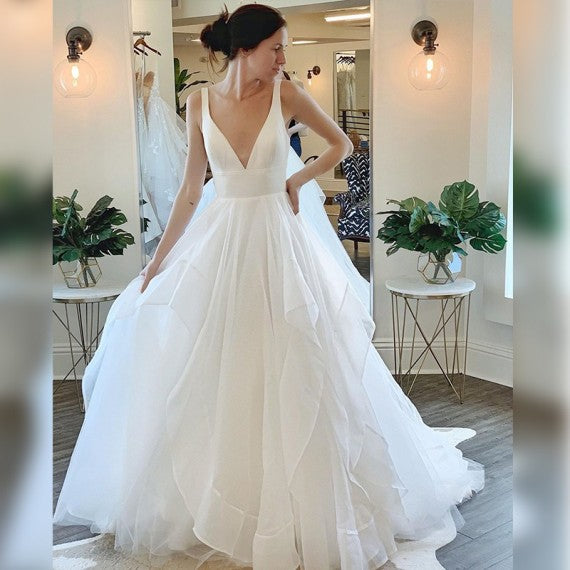 Ballbella offers Modern Deep V-neck Sleeveless White Tulle Wedding Dresses with Ruffless online at an affordable price from Tulle to A-line Floor-length skirts. Shop for Amazing Sleeveless collections for your bridal party.