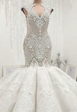 Inspired by this wedding dress at ballbella.com,Mermaid style, and Amazing Crystal work? We meet all your need with this Classic latest V Neck Cap Sleeve Beads Crystals Mermaid Wedding Dress Lace Applique.