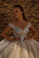 Looking for a dress in Satin, A-line style, and AmazingSequined,Rhinestone work? We meet all your need with this Classic Off the Shoulder Crystal Princess Ball Gown Sequins Bridal Gowns.