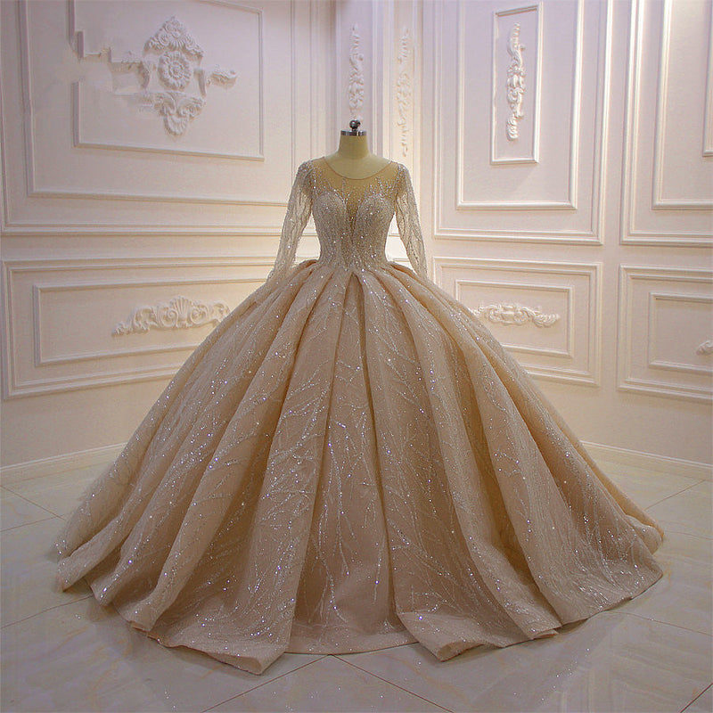 Wanna get a dress in Tulle, Ball Gown style, and delicate Beading,Appliques,Ruffless work? We meet all your need with this Classic Shiny Ball Gown Tulle Jewel Long Sleevess Ruffless Wedding Dress at factory price.