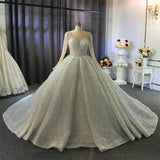 Wanna get a dress in Tulle, Ball Gown style, and delicate Beading,Appliques,Ruffless work? We meet all your need with this Classic Shiny Ball Gown Tulle Jewel Long Sleevess Ruffless Wedding Dress at factory price.