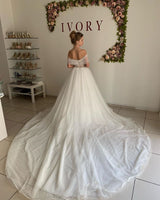 Ballbella offers Trendy Off-the-shoulder Princess Pearl White Ball Gown Wedding Dresses online at an affordable price from Tulle to A-line Floor-length skirts. Shop for Amazing collections for your bridal party.