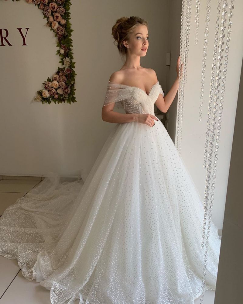 Ballbella offers Trendy Off-the-shoulder Princess Pearl White Ball Gown Wedding Dresses online at an affordable price from Tulle to A-line Floor-length skirts. Shop for Amazing collections for your bridal party.